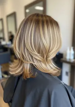 Dimensional balayage catching three distinct tones through the mid-lengths